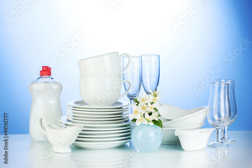 Vászonkép empty clean plates, glasses and cups with dishwashing liquid