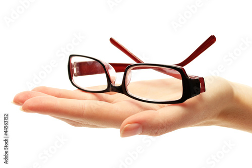 glasses on female hand, isolated on white