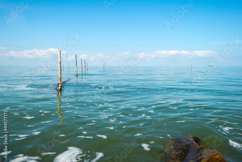 Fishnet in a lake under a blue sky