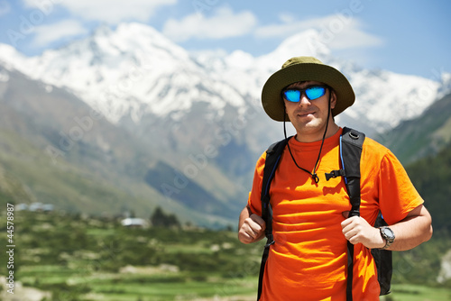 Tourist hiker with backpack in mountains