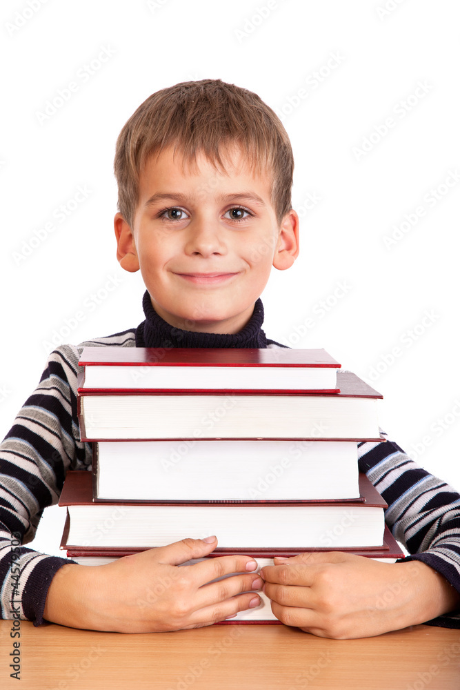 Schoolboy and a heap of books isolated on a white background Schoolboy and a heap of books isolated on a white background