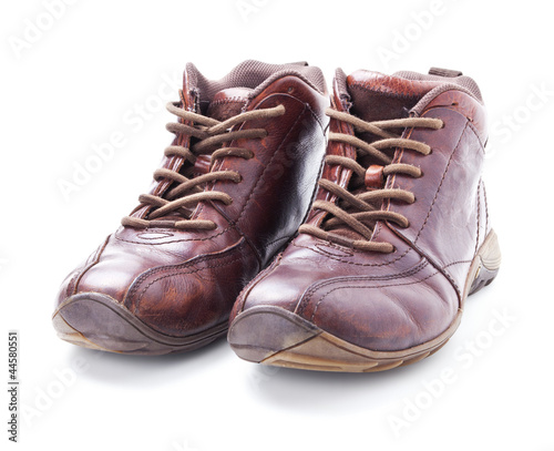 A pair of old brown boots isolated on white