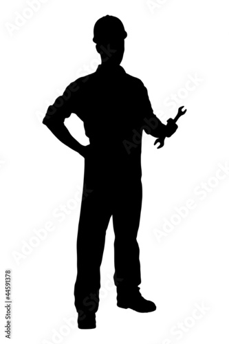 A silhouette of a confident and smiling handyman holding a wrenc