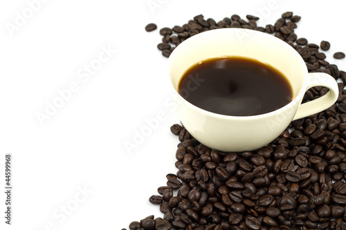 cup of hot coffee and coffee beans in white background