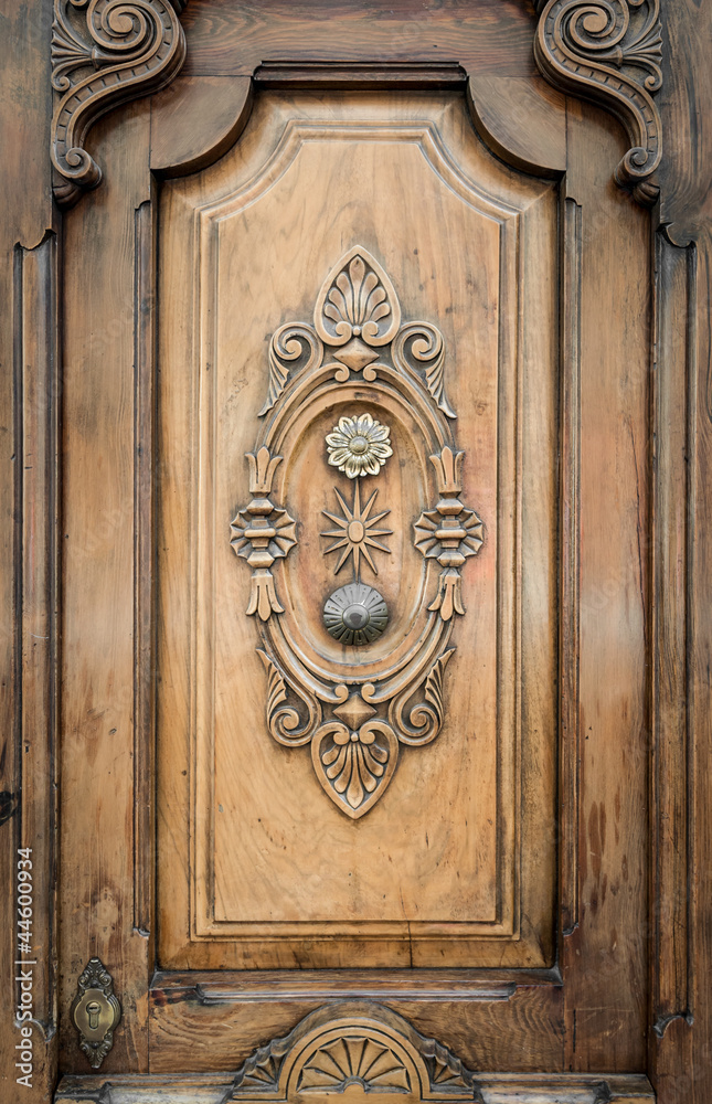 Old door of wood with patterns carved on it.