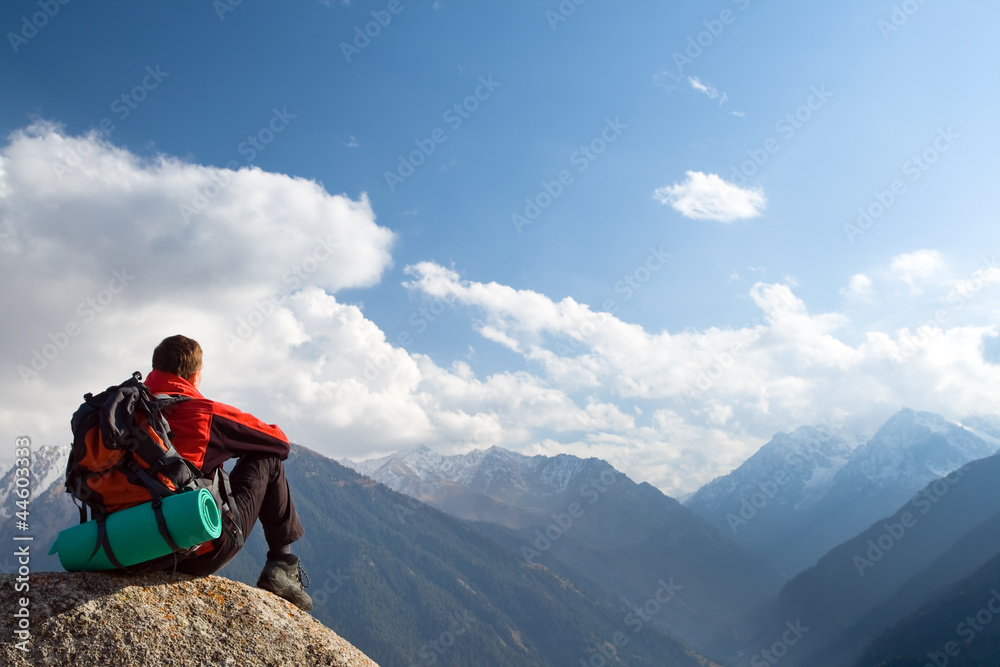 Naklejka premium Climbing young adult at the top of summit