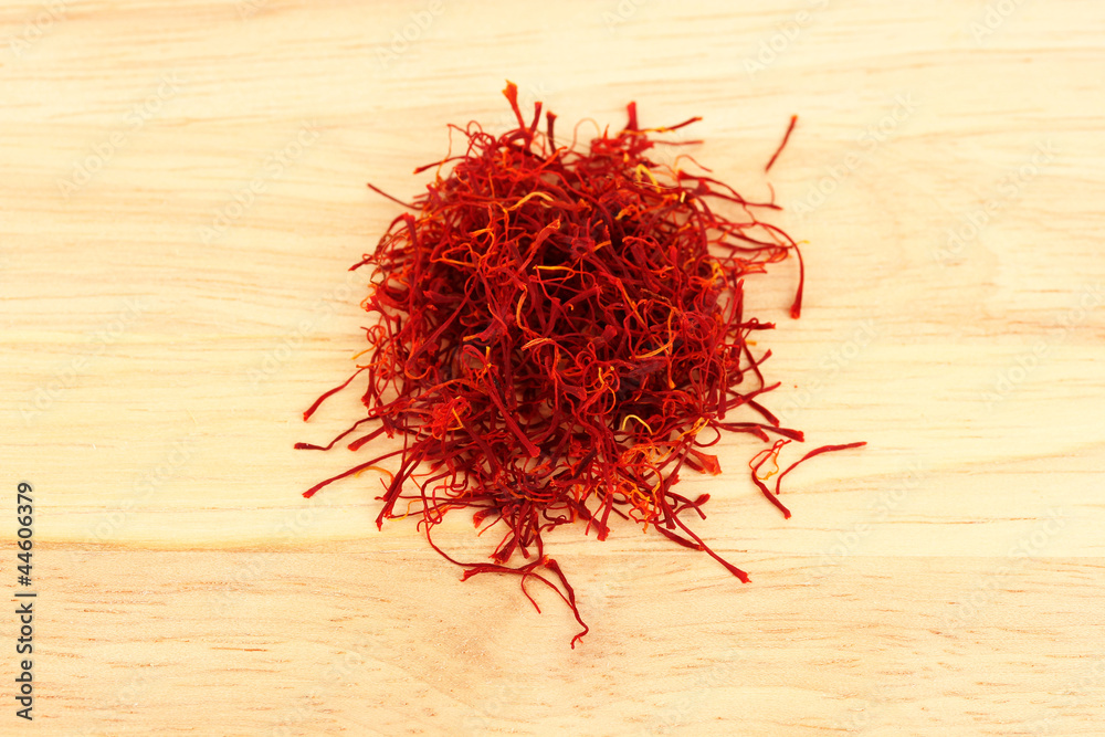 Fototapeta premium stigmas of saffron on wooden background close-up