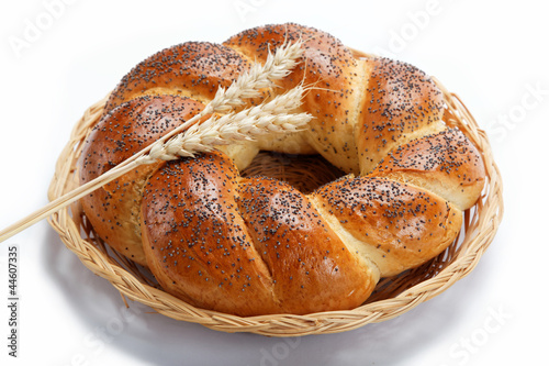 A fresh loaf of bread sprinkle with poppy seeds isolated on whit