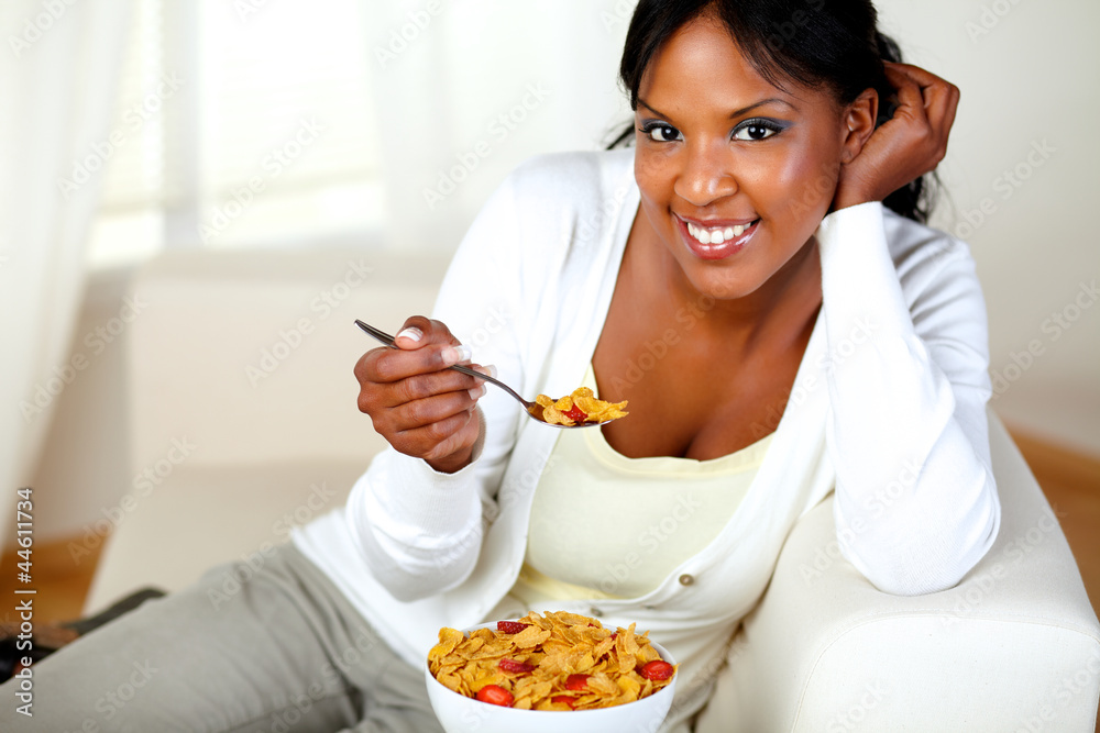 Young woman smiling at you and having breakfast Young woman smiling at you and having breakfast