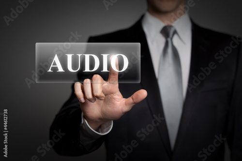 businessman pressing virtual button - audio