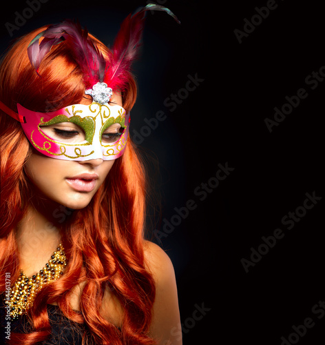 Beautiful Woman in a Carnival mask. Isolated on Black