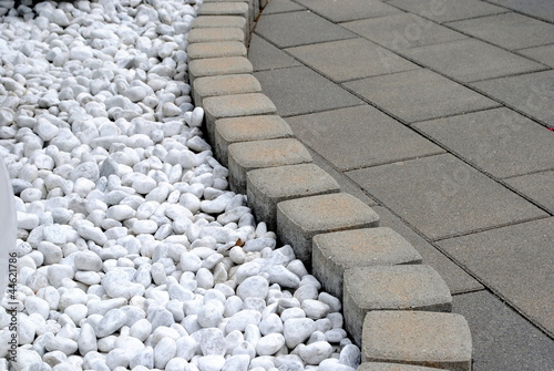 flower bed border made of pebbles and stones