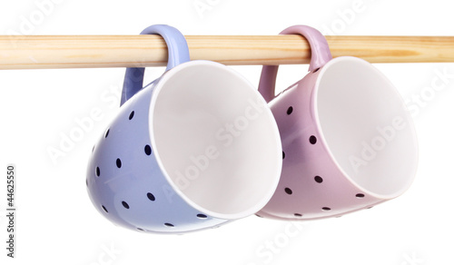 Nice cups hanging on stick isolated on white