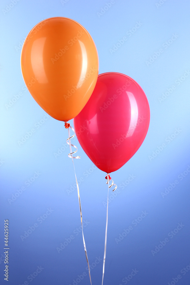 Two colorful balloons on blue background Two colorful balloons on blue background