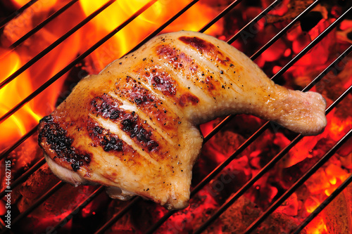 grilled chicken thigh on the flaming grill