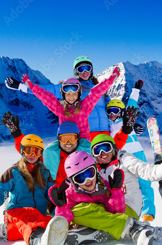 Skiing, winter fun - happy skiers, family ski team