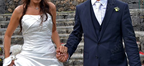 Bride and groom holding hands photo