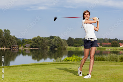 Golf player teeing off