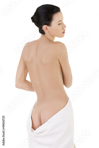 Young beautiful nude woman with towel