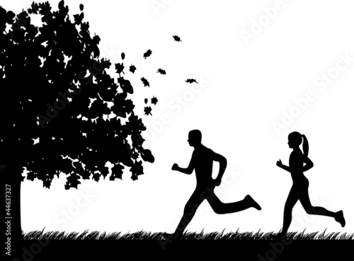 Girl and man running in park in autumn or fall silhouette