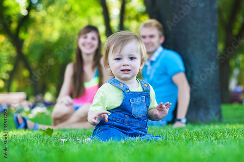 baby with parents in a beautiful summer park
