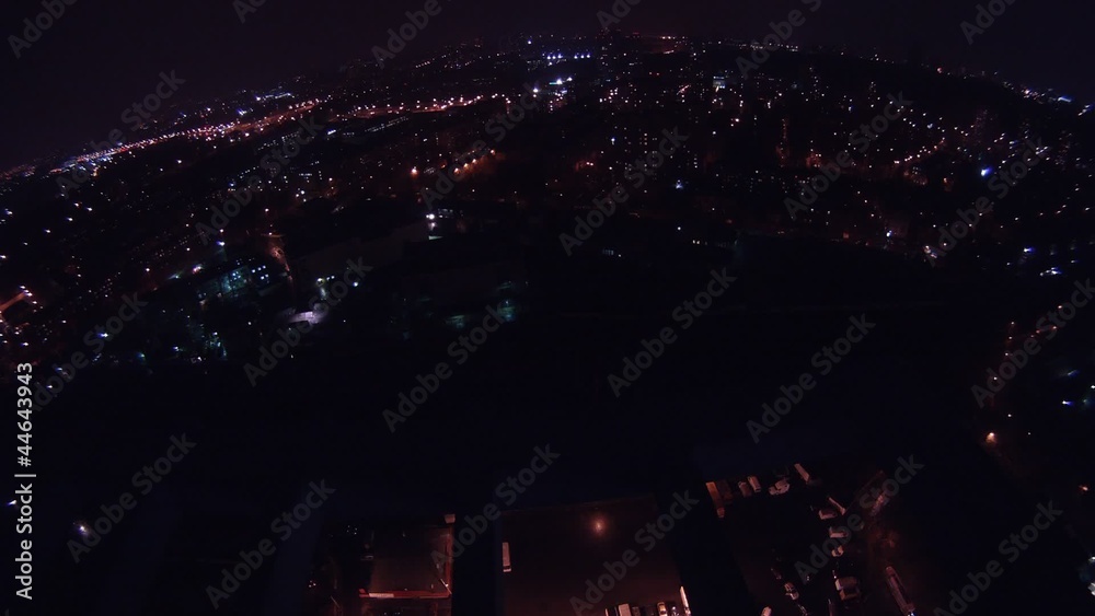 Night city is shone by light in windows of houses and cars Night city is shone by light in windows of houses and cars