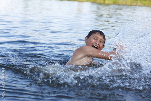 boy in river with splash