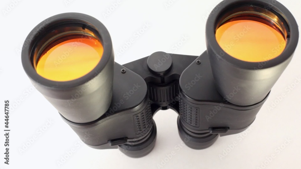 one black field-glass rotates on white support one black field-glass rotates on white support