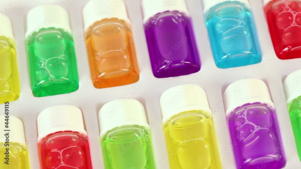 White box rotates with set of color oil in bottles White box rotates with set of color oil in bottles