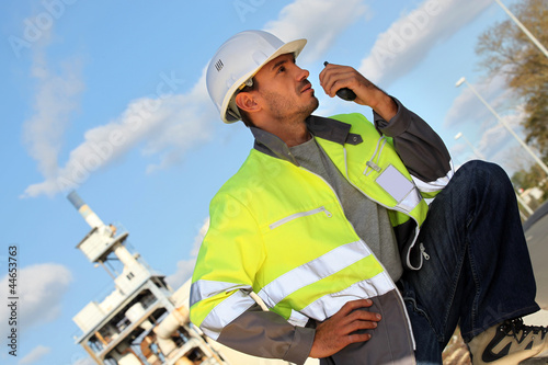 Traffic guard speaking into his walkie talkie photo