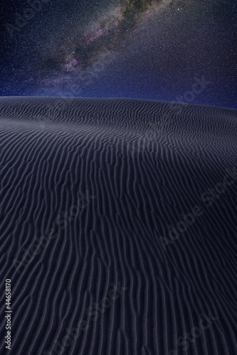 Desert dunes sand in milky way stars night sky