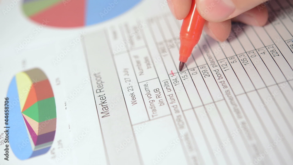 Businessman analyses market report Businessman analyses market report