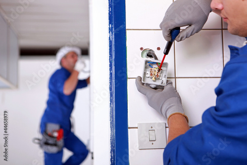 craftsman working on the electricity installation photo