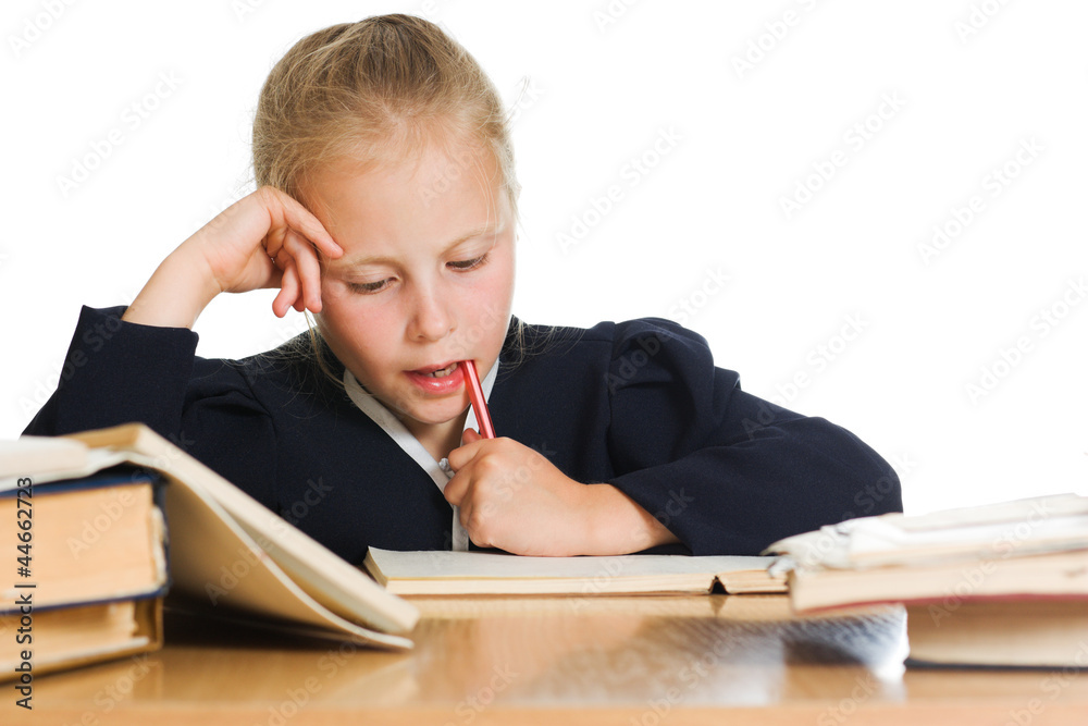 Schoolgirl writes at a table