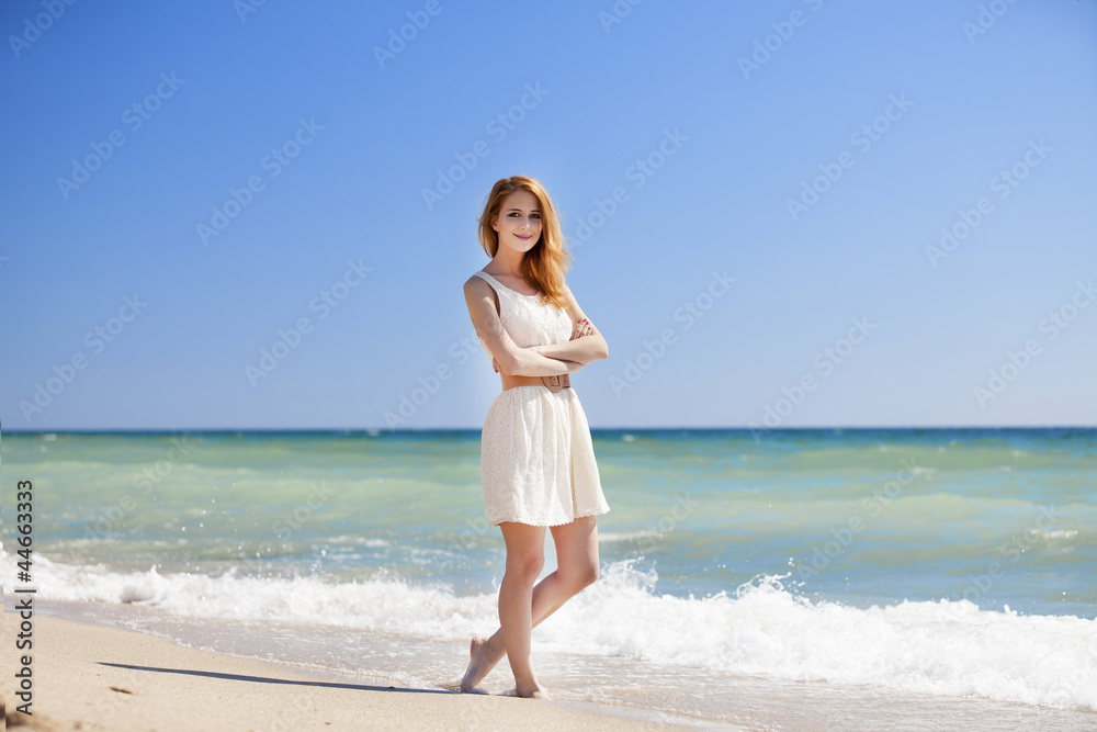Young redhead girl at the beach. Young redhead girl at the beach.