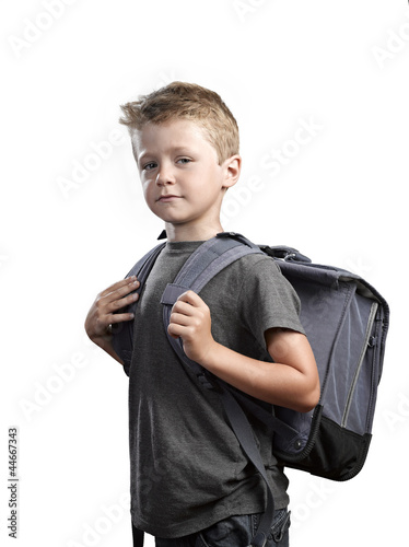 Young boy with backpack isolated on white background photo