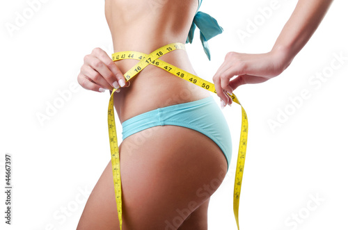 Young lady with centimetr in weight loss concept