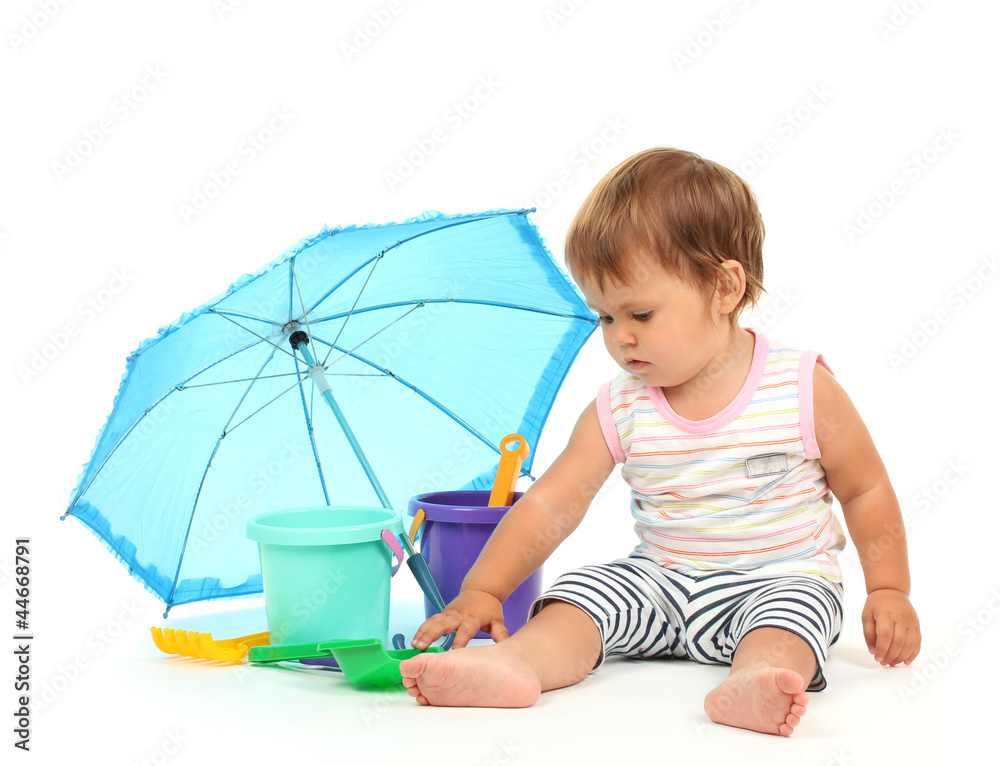 Cute baby with bucket and spade near umbrella isolated on white