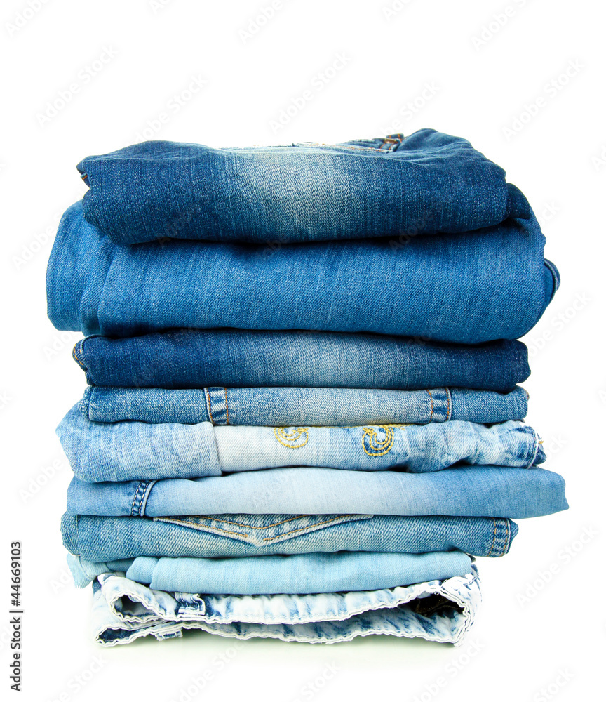Lot of different blue jeans isolated on white Lot of different blue jeans isolated on white