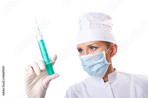 Woman doctor with syringe on white