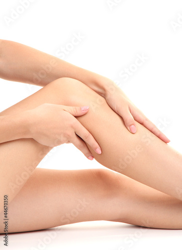 woman holding sore knee  isolated on white