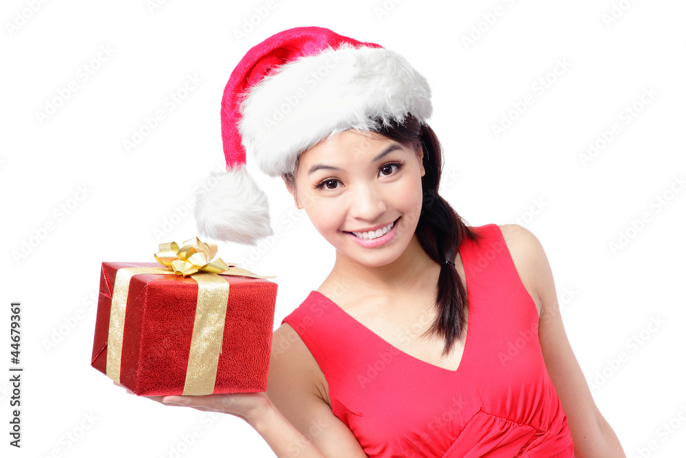 happy woman in santa hat showing Christmas present happy woman in santa hat showing Christmas present