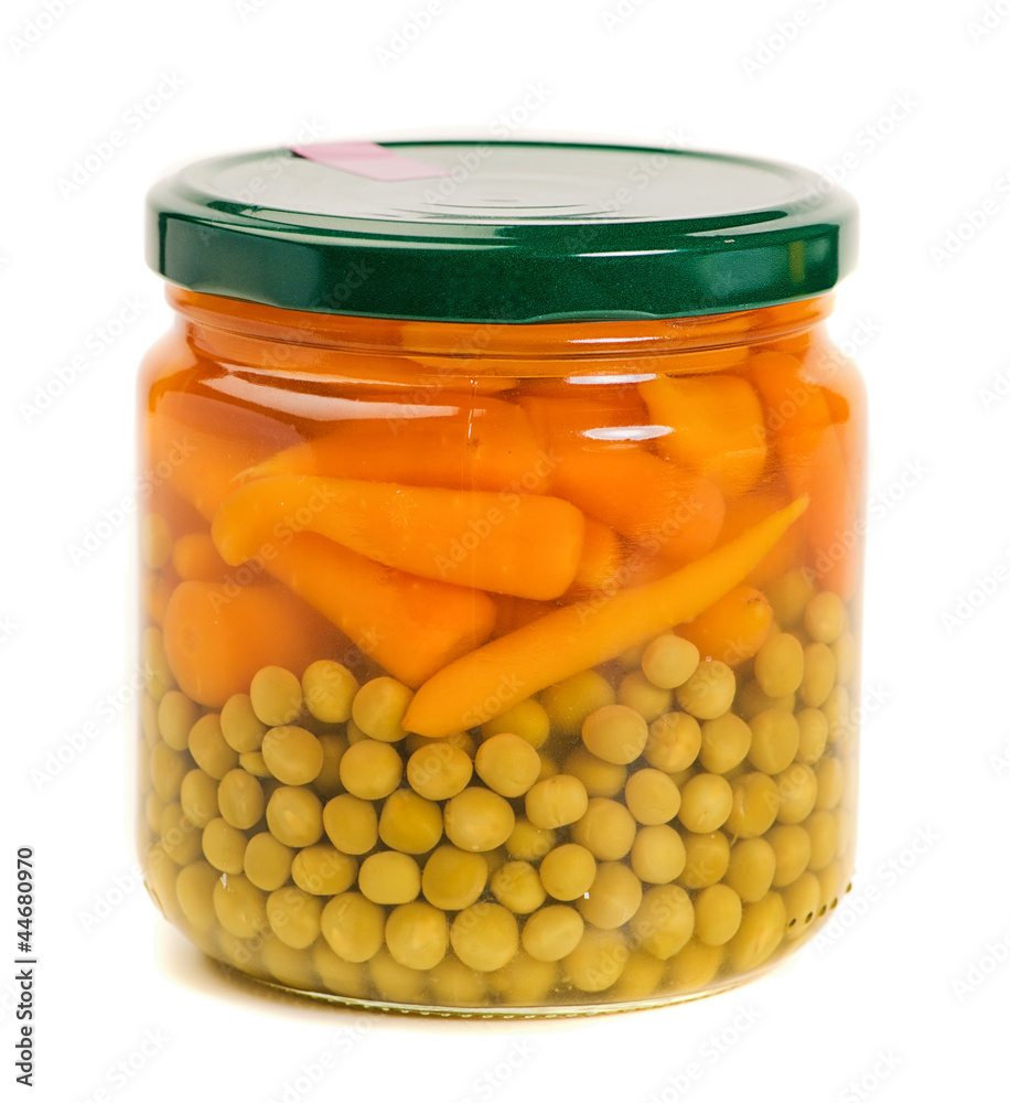 fresh carrots and green peas in a glass jar fresh carrots and green peas in a glass jar