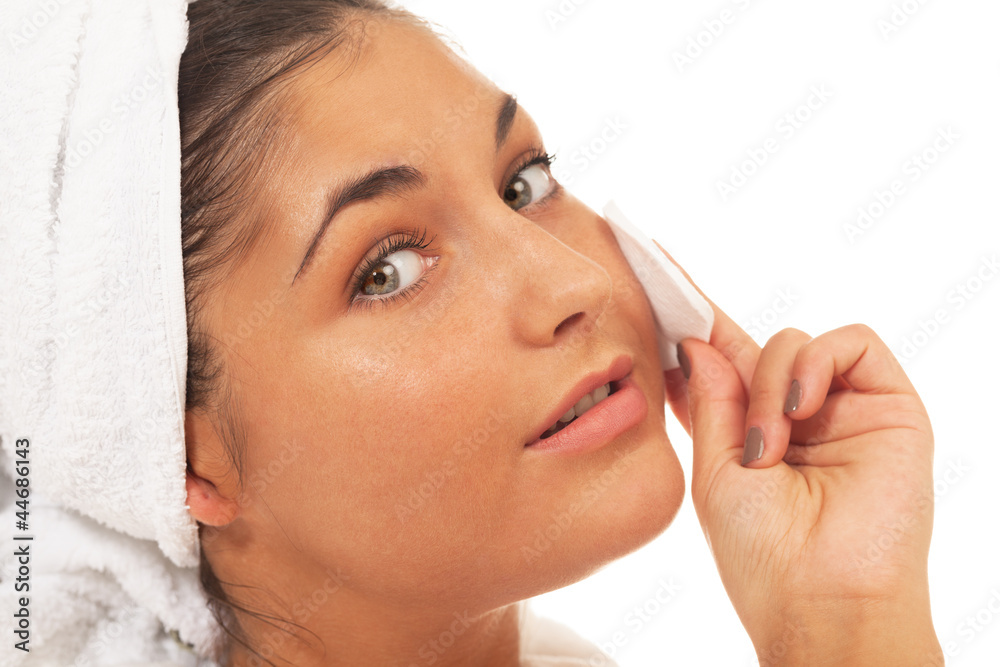 Girl with cotton pad on isolated white Girl with cotton pad on isolated white