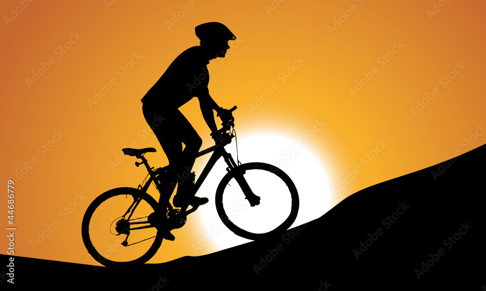 Obraz premium silhouette of a cyclist with sunset background