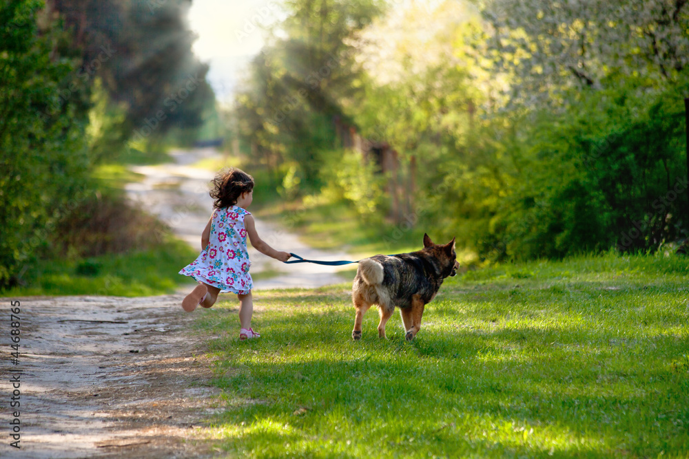 Little girl with dog running on the road to the sun Little girl with dog running on the road to the sun