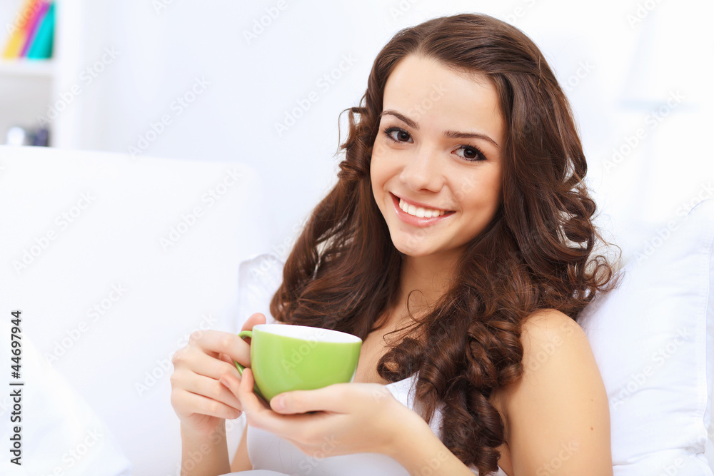 Young woman having cup of tea at home Young woman having cup of tea at home