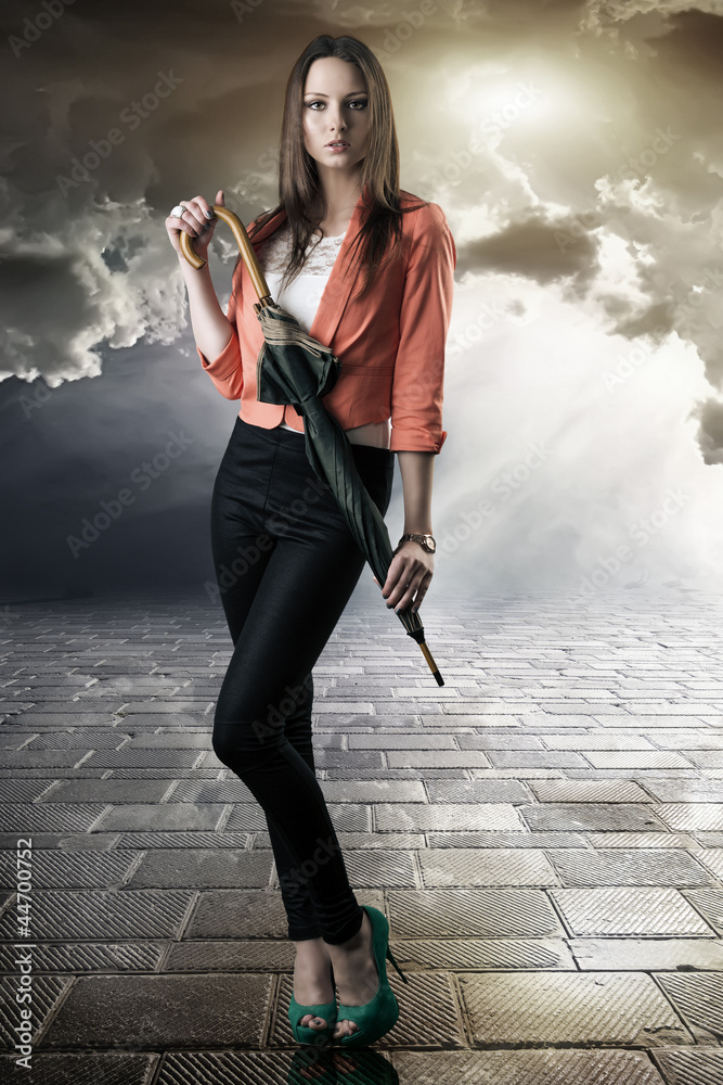 Naklejka premium beautiful woman with closed umbrella