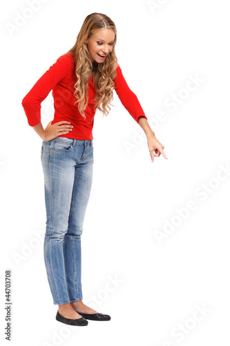 blonde woman pointing down on white background