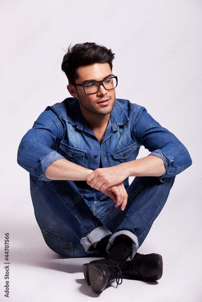 man wearing jeans shirt and glasses, sitting man wearing jeans shirt and glasses, sitting